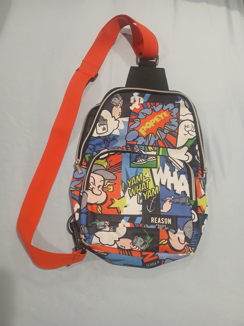 Reason Comic-Print Sling Bag with Orange Strap